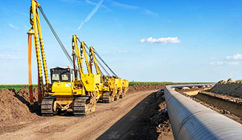 Pipeline equipment working with a sunset