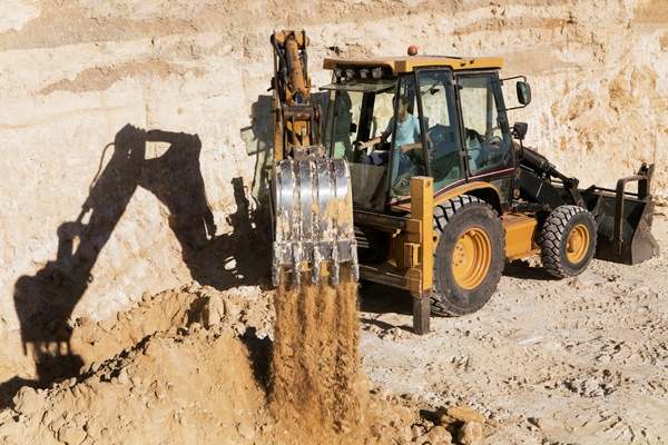 Excavation and grading operations using heavy machinery in Worcester, Massachusetts