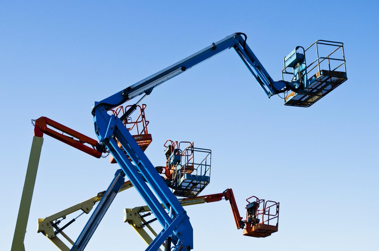 LIFT BUCKETS IN THE AIR AGAINST A CLEAR BLUE SKY.